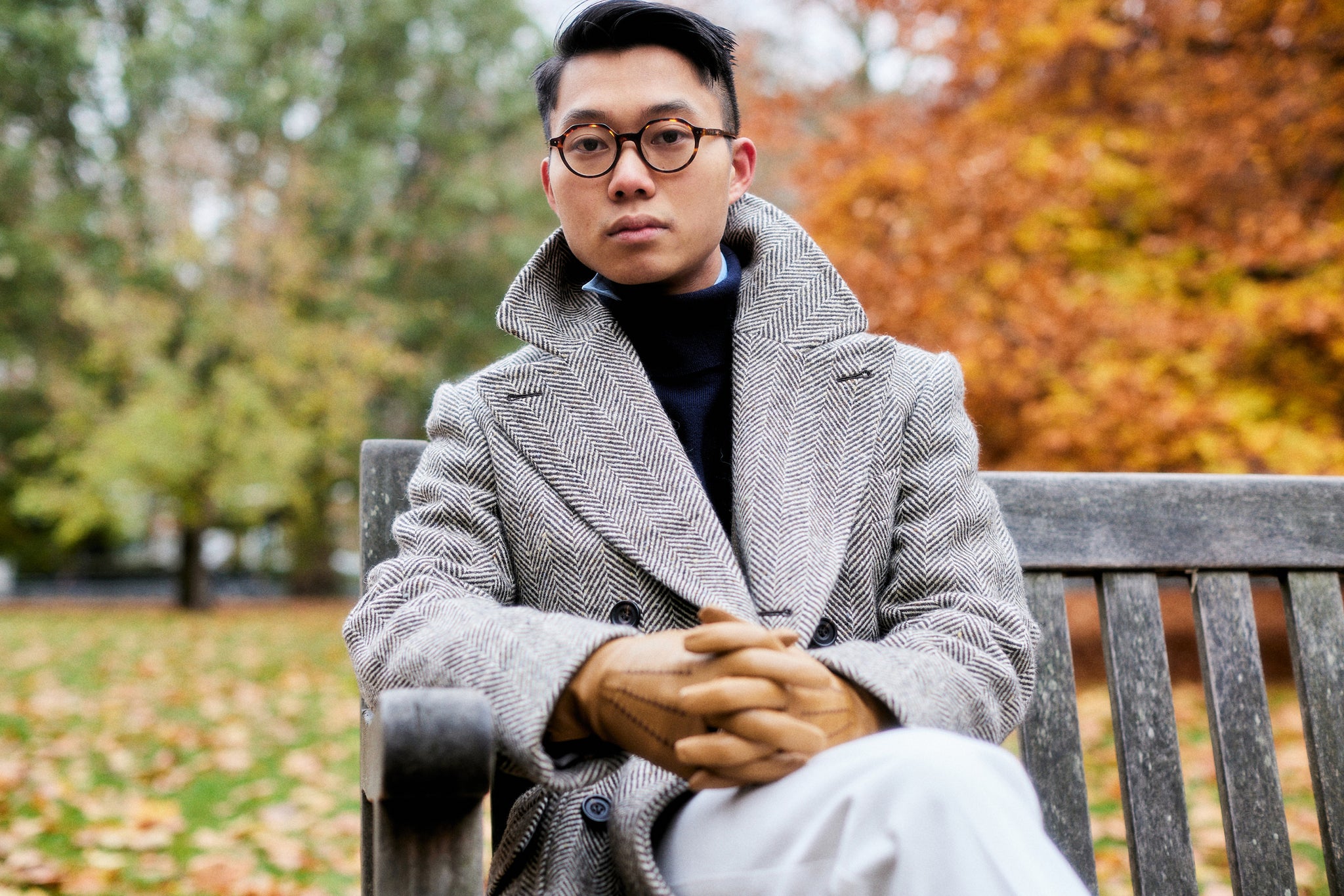 Buzz Tang wearing a grey coat that is a collaboration between his brand The Anthology and Permanent Style, interviewed by A Collected Man London