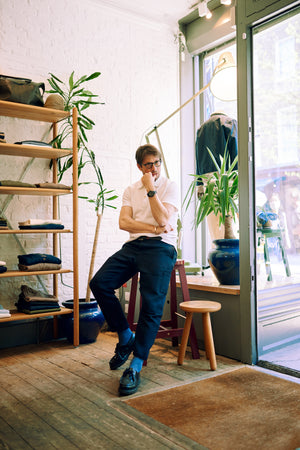 Oliver Spencer a middle-aged man wearing a white shirt sitting in his Oliver Spencer store interview by A Collected Man