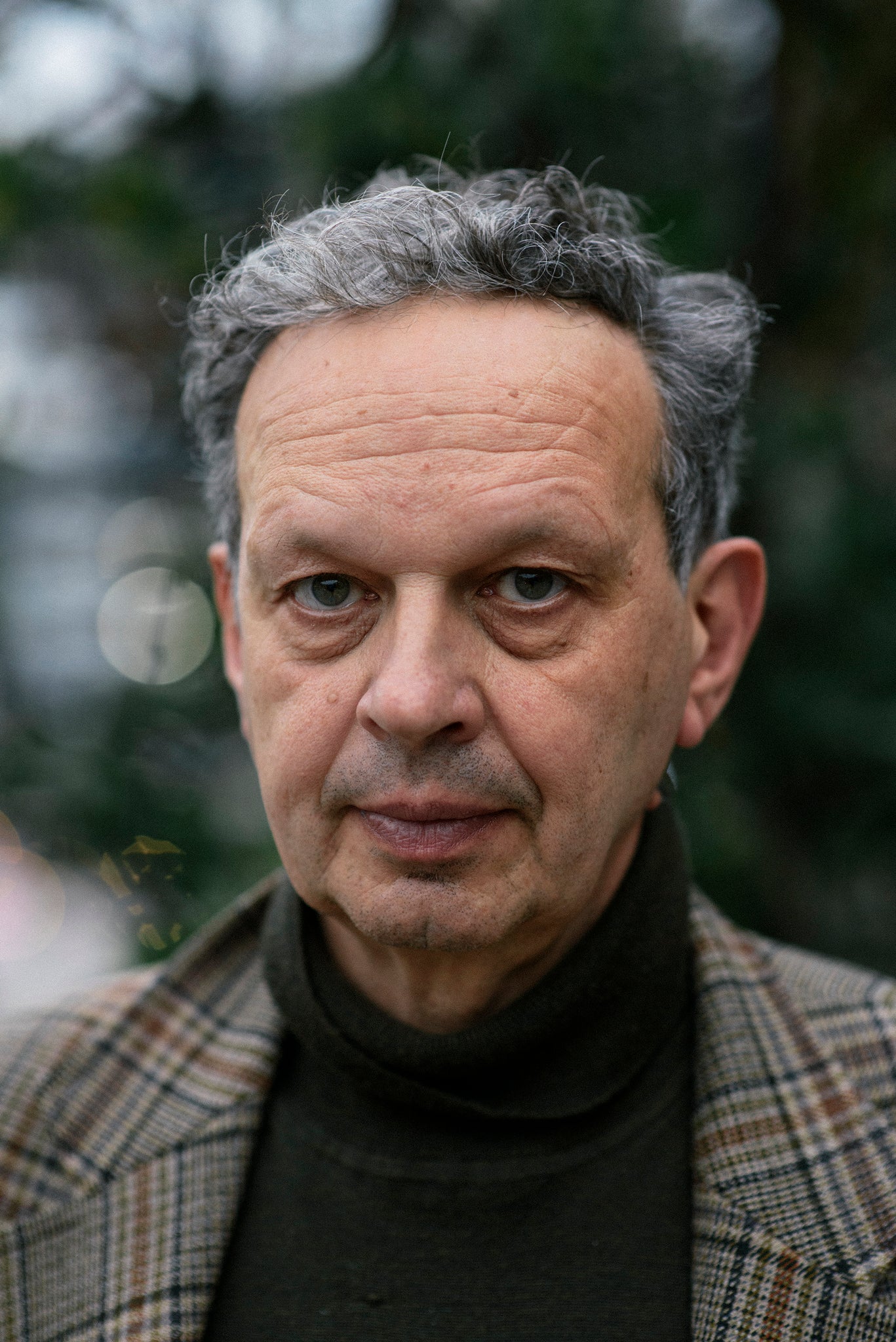 Headshot of Tom Dixon, slightly greying man in a black turtleneck and brown suit jacket